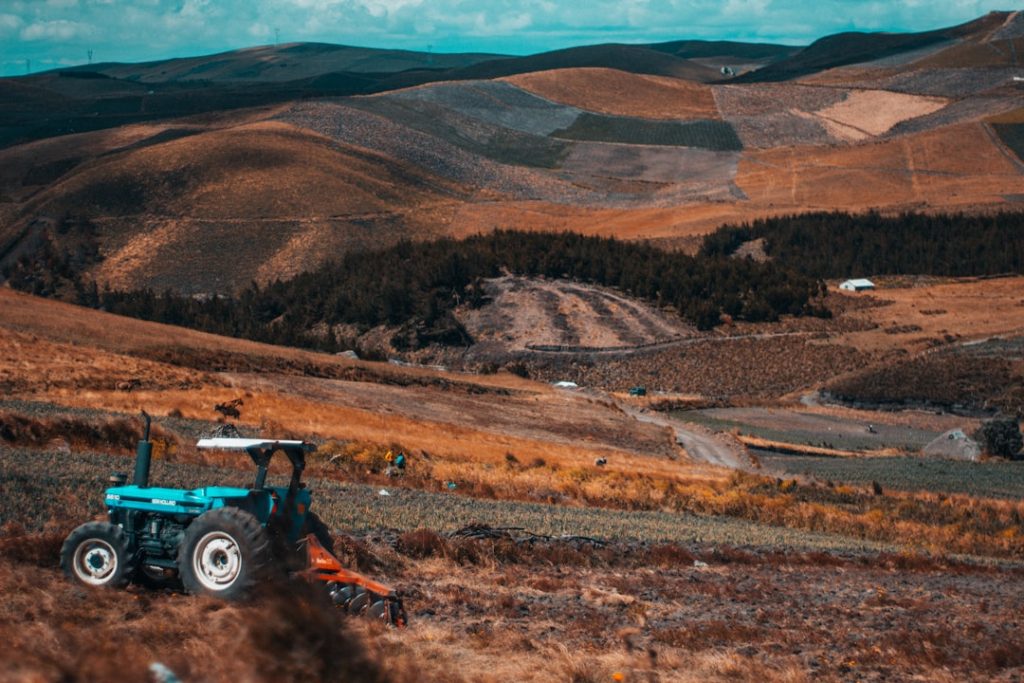 blue-and-black-tractor-on-field-during-daytime-i60-tcesa3k